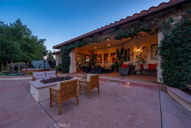 view of patio / terrace with an outdoor living space with a fire pit