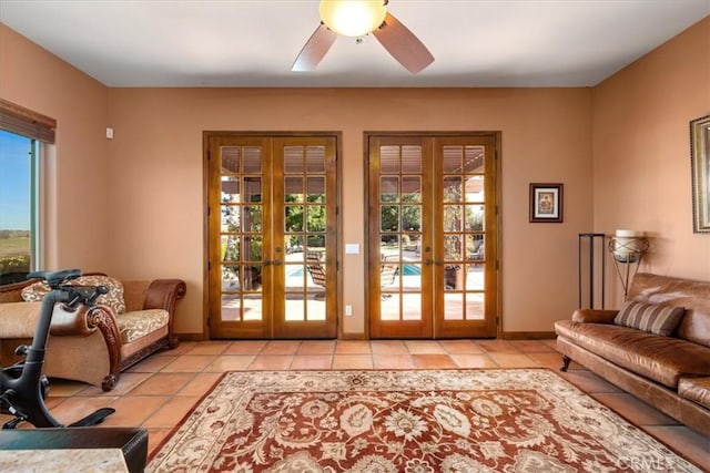 doorway featuring light tile patterned floors, ceiling fan, french doors, and baseboards