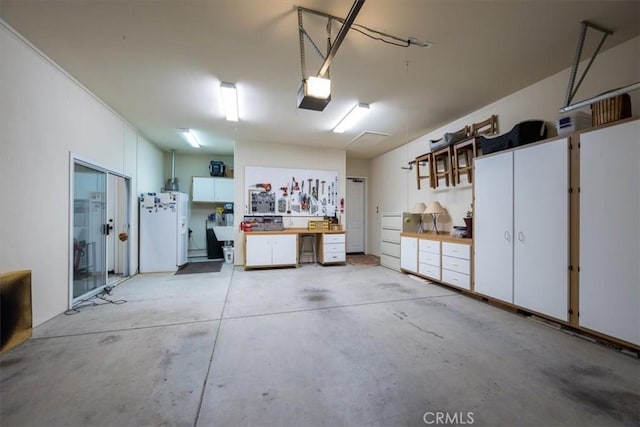 garage with a workshop area and a garage door opener