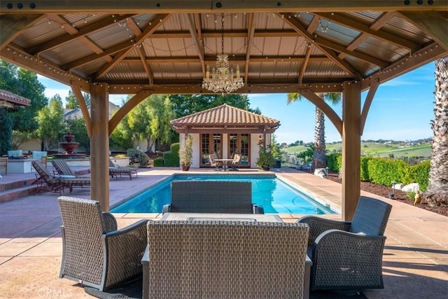 pool featuring a storage structure, an outdoor structure, a patio, and a gazebo