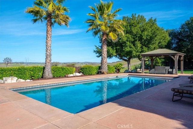 outdoor pool with a patio and a gazebo