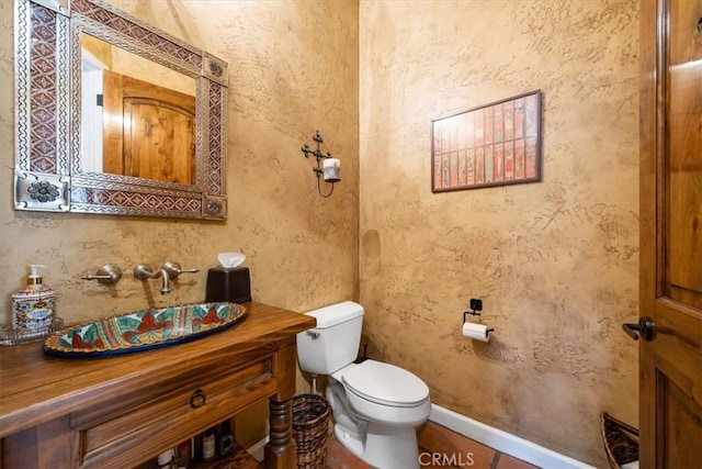 bathroom with toilet and vanity