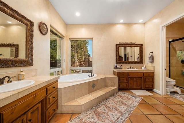 bathroom featuring tile patterned floors, a sink, a shower stall, and a bath