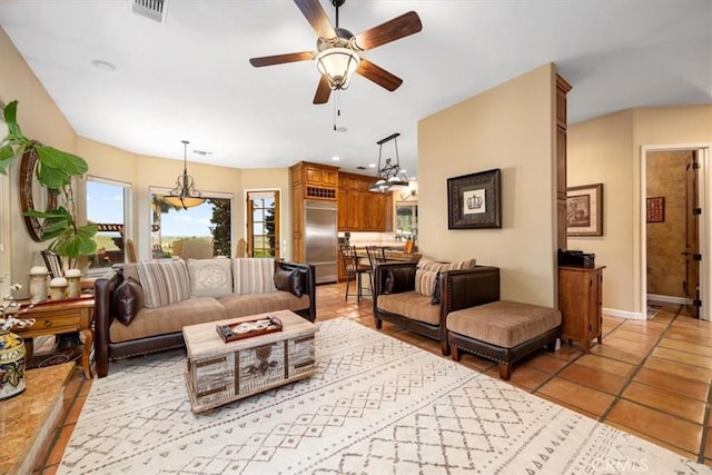 living area with baseboards, visible vents, a ceiling fan, and light tile patterned flooring