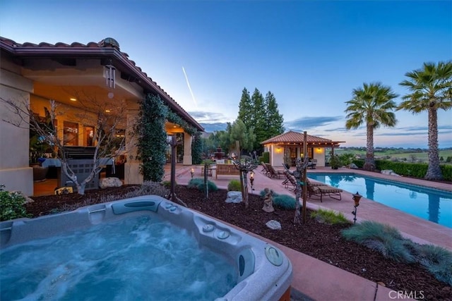 pool featuring a gazebo, an outdoor hot tub, and a patio