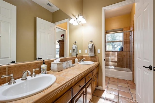 bathroom featuring tile patterned flooring, visible vents, a sink, and double vanity