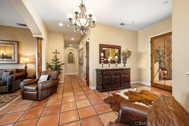 interior space featuring baseboards, recessed lighting, visible vents, and ornate columns