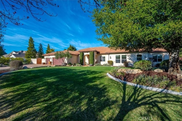 view of front of house featuring stucco siding and a front yard