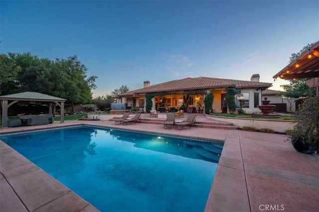 outdoor pool featuring a gazebo and a patio area