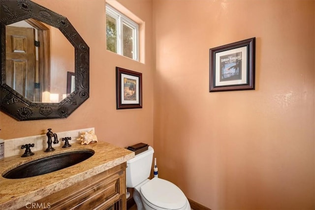 bathroom with toilet and vanity