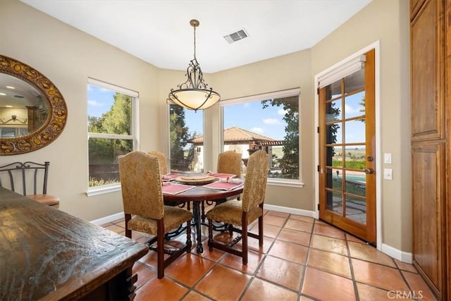 dining room with baseboards, visible vents, and light tile patterned flooring