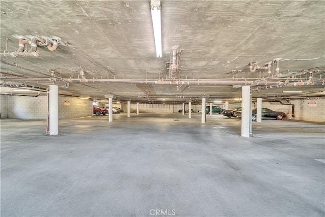 parking deck featuring concrete block wall