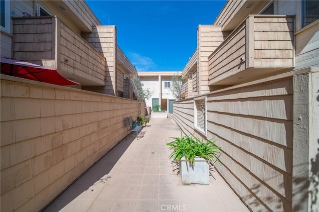 view of side of property with a patio area and fence