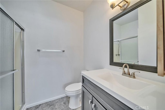 full bath featuring toilet, baseboards, an enclosed shower, and vanity