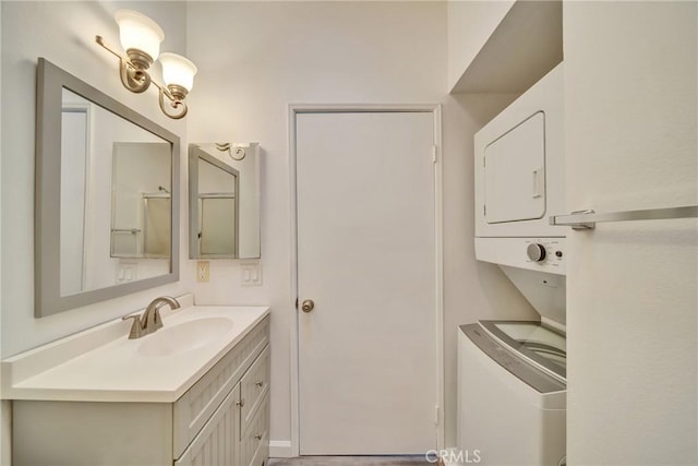 bathroom with stacked washer and dryer and vanity