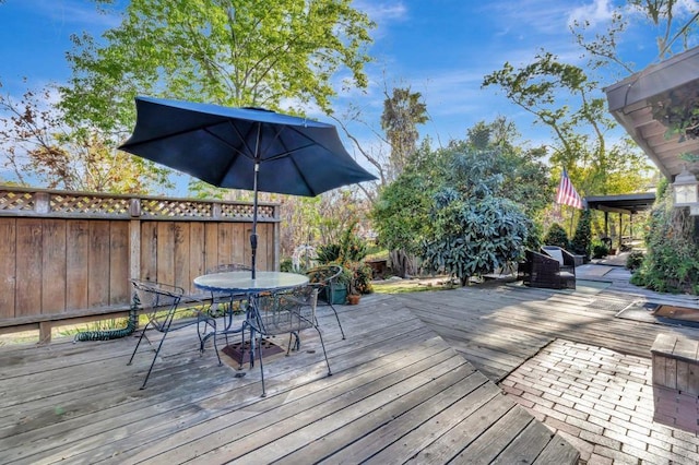 wooden terrace featuring outdoor dining space