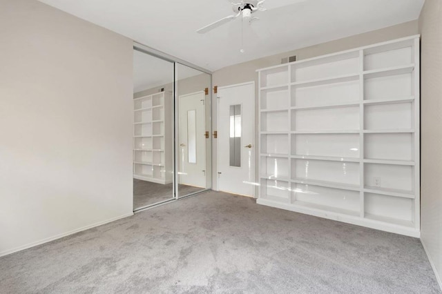 unfurnished bedroom with visible vents, a ceiling fan, and carpet