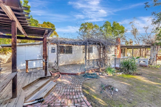 view of patio featuring a deck and electric panel
