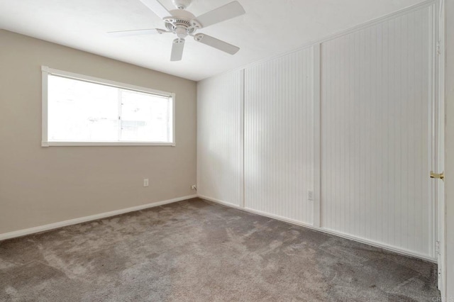 unfurnished room featuring carpet floors, ceiling fan, and baseboards
