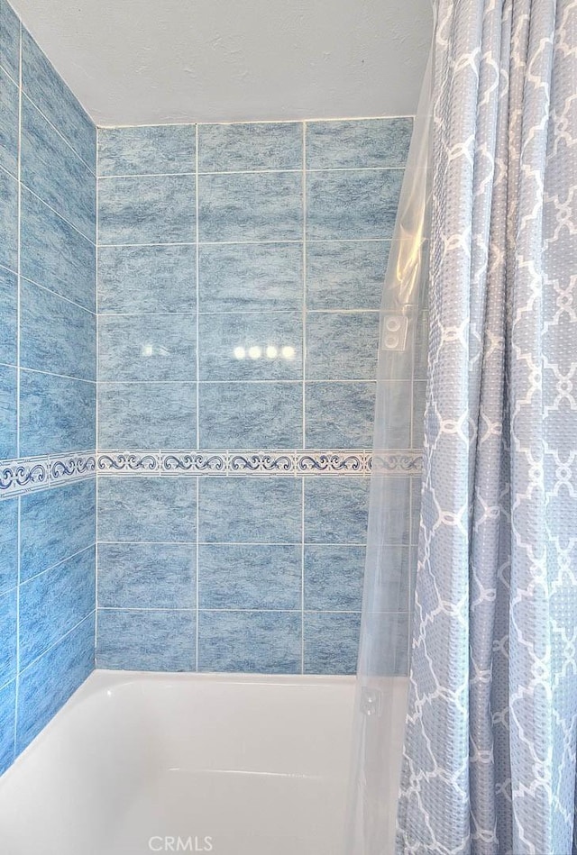 full bath featuring shower / bathtub combination with curtain