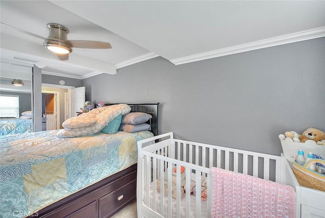 bedroom featuring a ceiling fan, visible vents, and crown molding