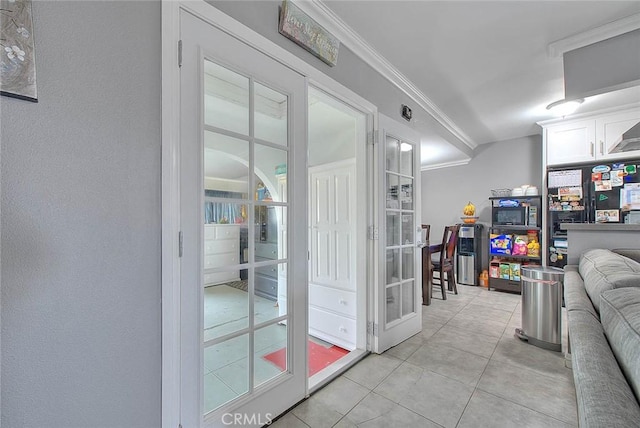 interior space with crown molding and light tile patterned flooring