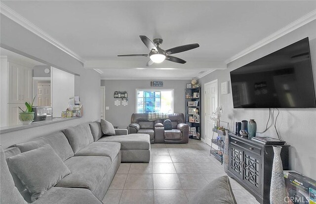 living room featuring light tile patterned floors, ornamental molding, and a ceiling fan