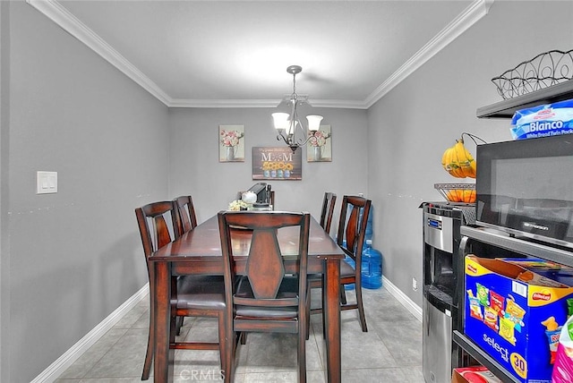 dining space featuring a chandelier, crown molding, baseboards, and tile patterned floors