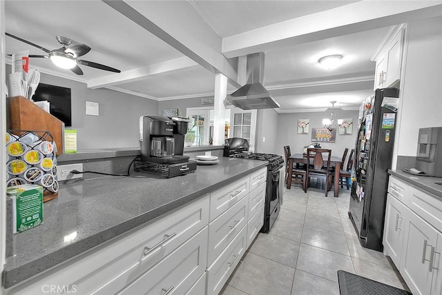 kitchen featuring extractor fan, light tile patterned flooring, freestanding refrigerator, gas stove, and crown molding