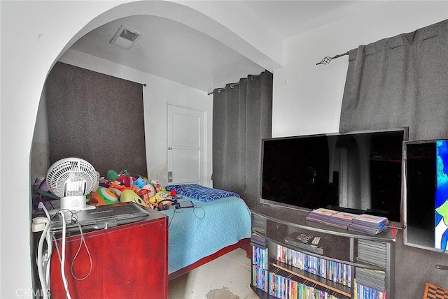 bedroom featuring visible vents and arched walkways