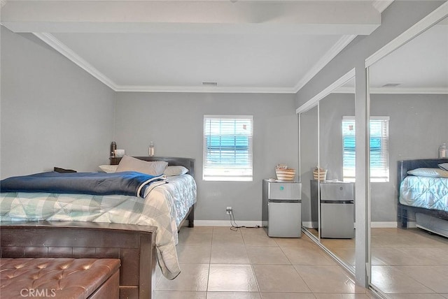 tiled bedroom with visible vents, freestanding refrigerator, and crown molding