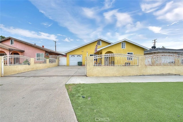 view of front facade with a fenced front yard, a gate, concrete driveway, and stucco siding