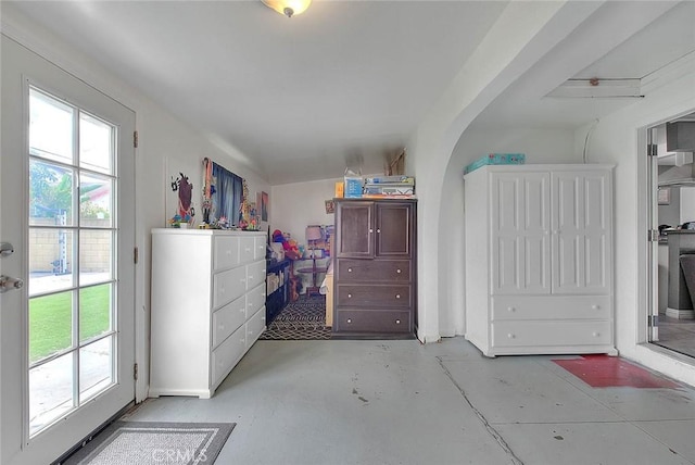 unfurnished bedroom featuring access to outside and concrete flooring