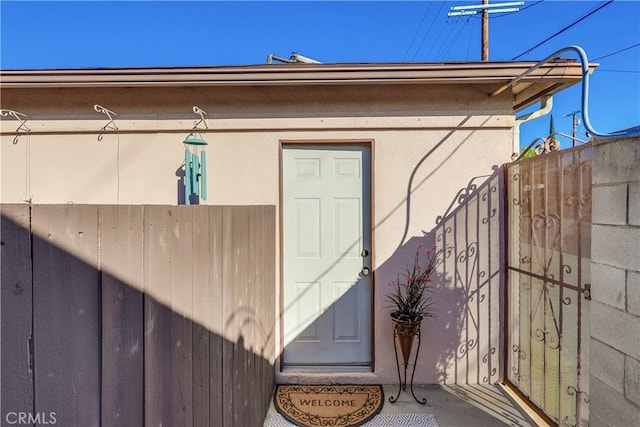 view of exterior entry featuring fence