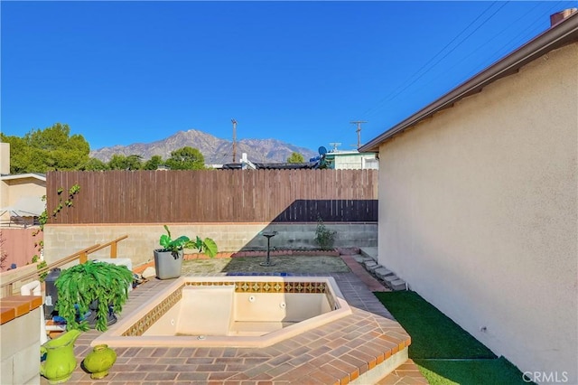 view of patio / terrace with a fenced backyard and a mountain view