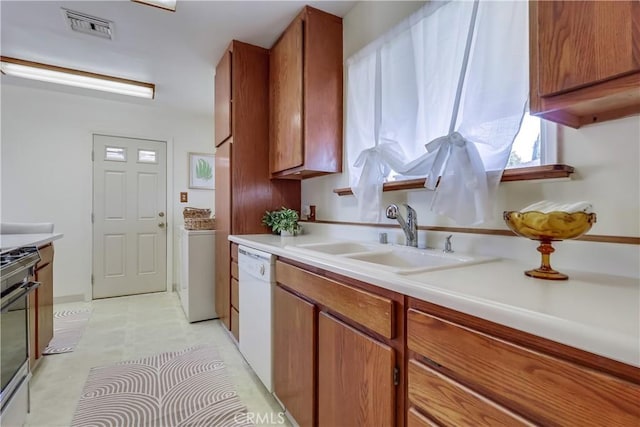 kitchen with stainless steel range, visible vents, brown cabinetry, white dishwasher, and a sink