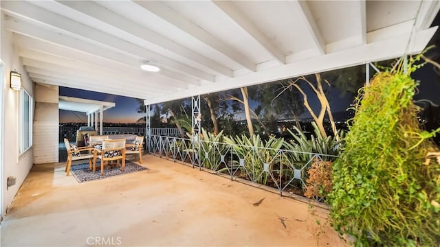 sunroom featuring beamed ceiling