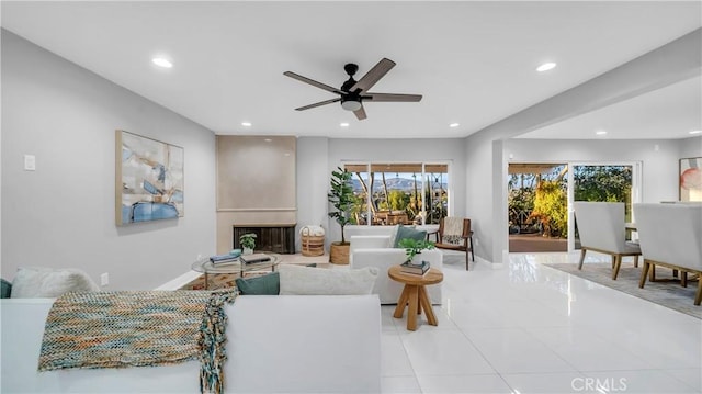 living room with light tile patterned flooring, a fireplace, baseboards, and recessed lighting