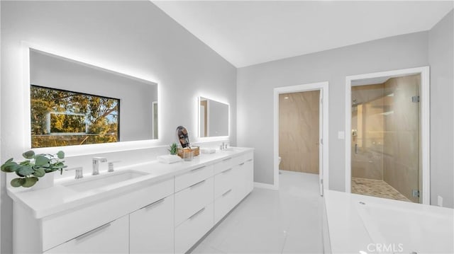 bathroom with double vanity, a stall shower, toilet, tile patterned floors, and a sink