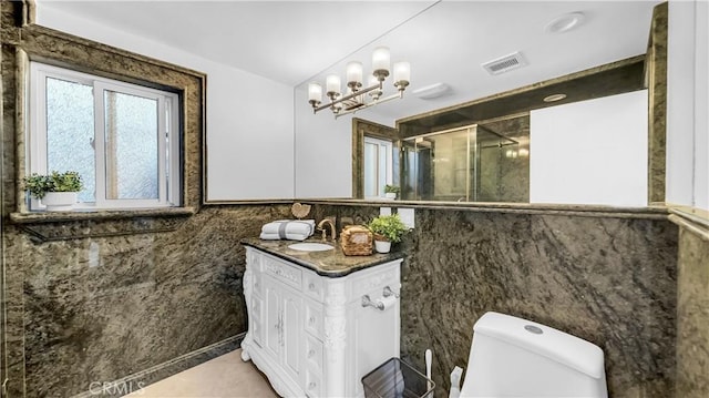 bathroom with vanity, visible vents, toilet, a stall shower, and a notable chandelier