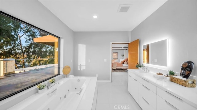 ensuite bathroom featuring a jetted tub, tile patterned flooring, ensuite bath, and vanity