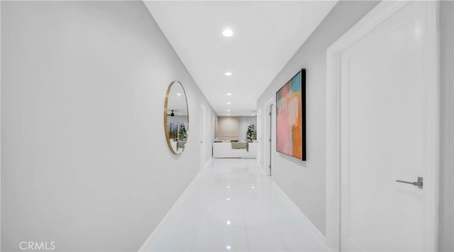 hallway featuring tile patterned flooring, recessed lighting, and baseboards