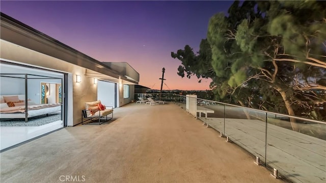 patio terrace at dusk with a balcony