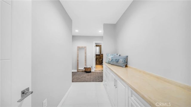 hallway featuring recessed lighting and baseboards