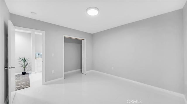 bedroom with baseboards and a closet