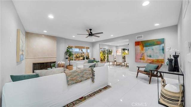 tiled living area featuring a ceiling fan, recessed lighting, visible vents, and baseboards