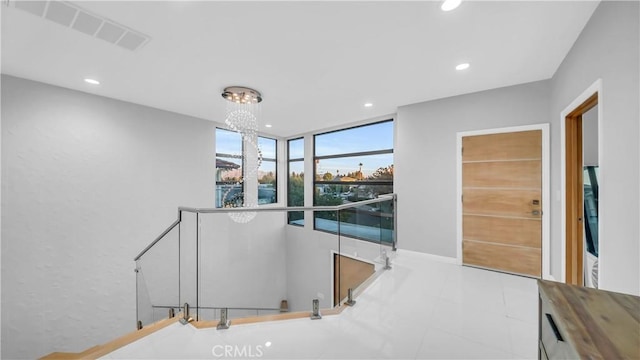 hall featuring recessed lighting, visible vents, an upstairs landing, and a chandelier