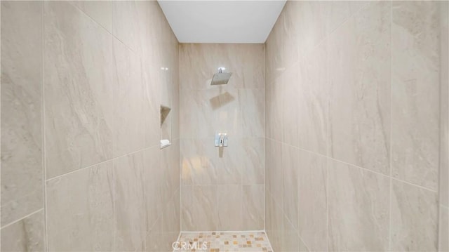 full bath with a tile shower