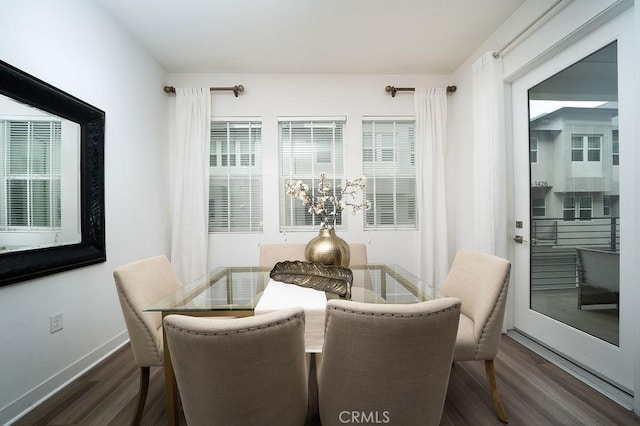 dining room featuring baseboards and dark wood-type flooring