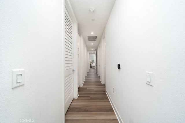 corridor with recessed lighting, baseboards, visible vents, and light wood finished floors